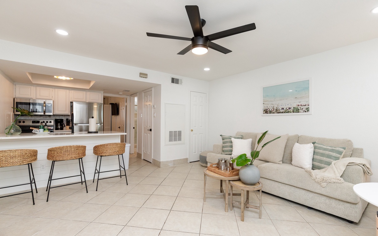 Relax in your bright, modern living space with coastal touches and a fully equipped kitchen perfect for preparing meals during your stay.