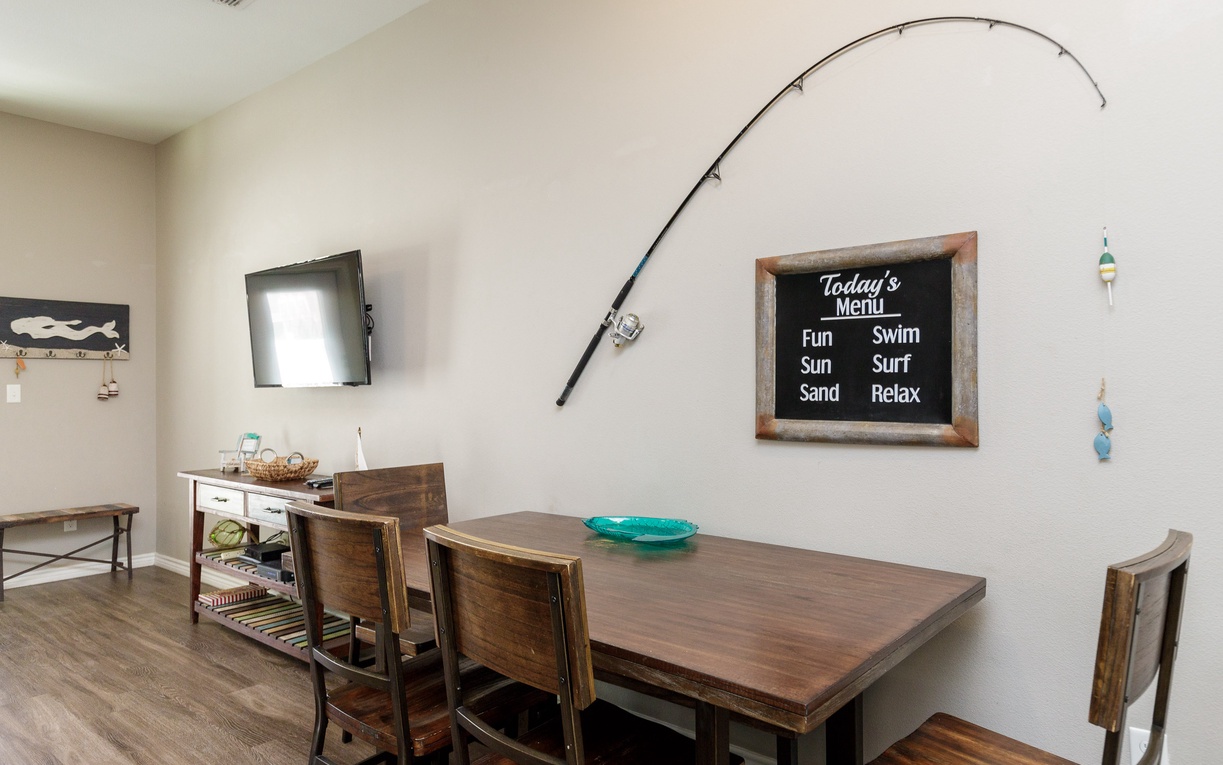 Gather around your stylish dining table where beach-themed décor and a fun daily menu board set the perfect tone for memorable meals together.
