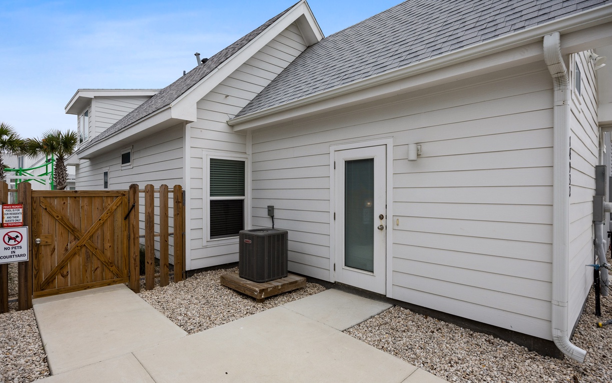 Modern coastal property featuring clean white siding and efficient climate control for comfortable year-round stays.