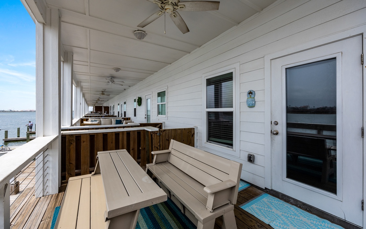 Your private waterfront balcony awaits with comfortable seating and stunning water views, perfect for morning coffee or sunset relaxation.