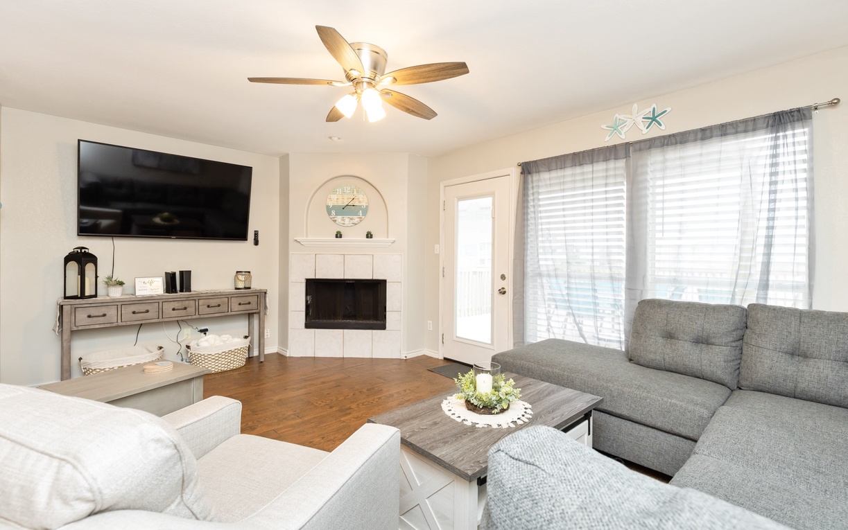 Unwind in this bright, coastal-themed living room where plush seating create your perfect retreat.