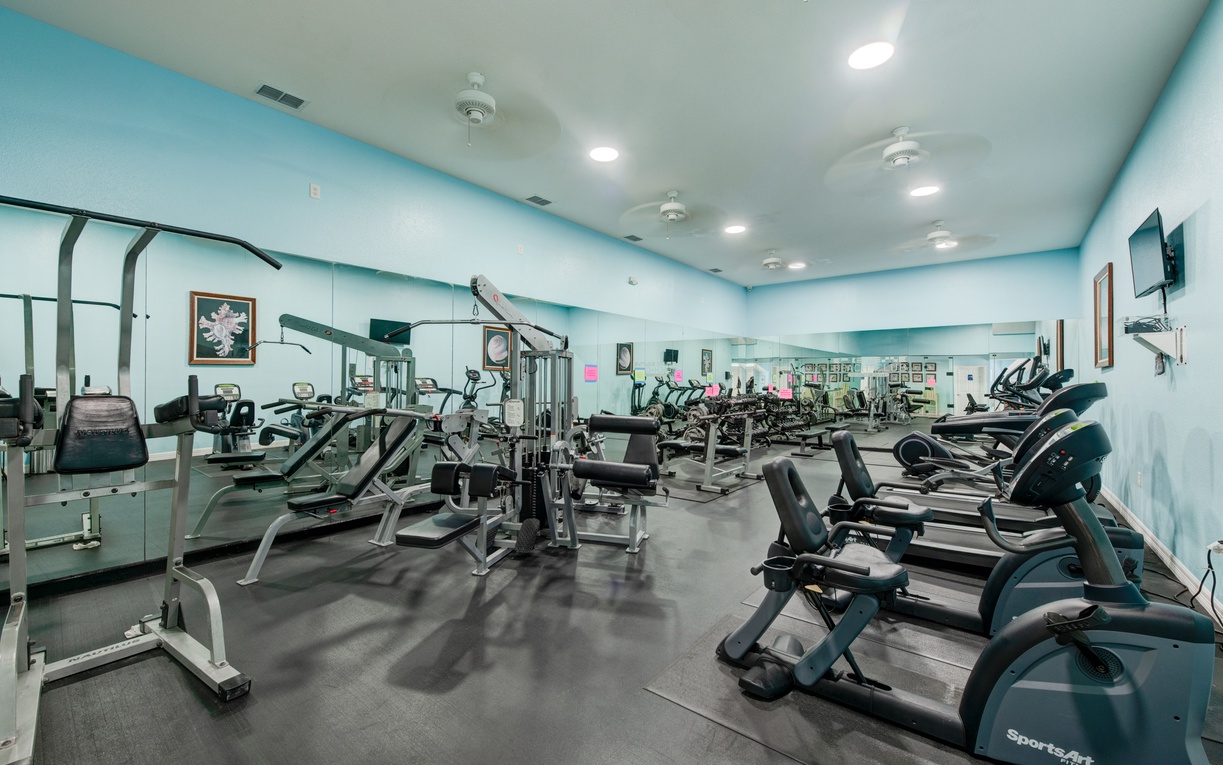 Your modern fitness center awaits with cardio machines, strength equipment, and motivational energy to power through your workout routine.