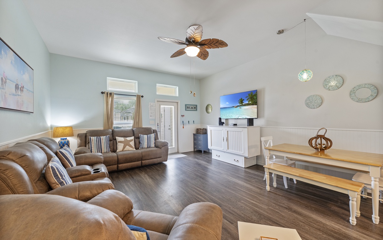 Sink into plush recliners and unwind in your spacious living room, complete with coastal decor and flat-screen TV for perfect vacation evenings.