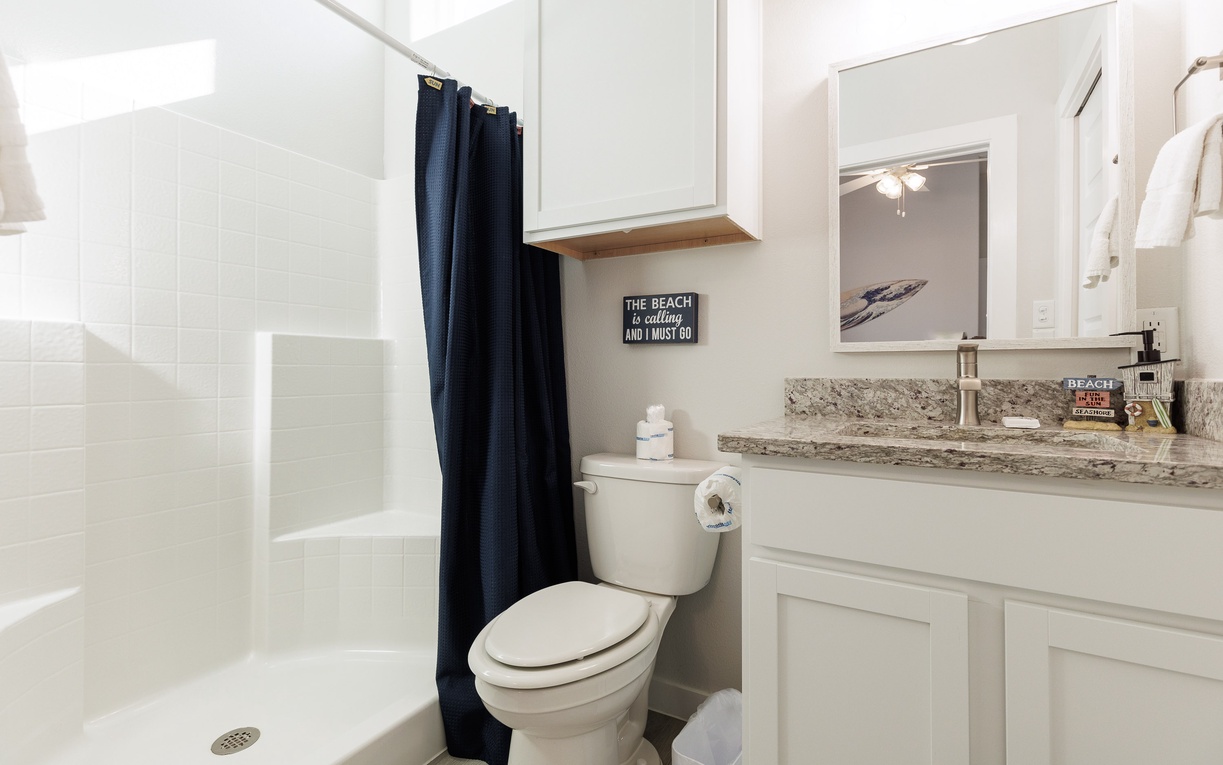 Refresh in your coastal-themed bathroom with granite counters, beach décor, and a spacious glass shower—perfect for unwinding after beachside adventures.