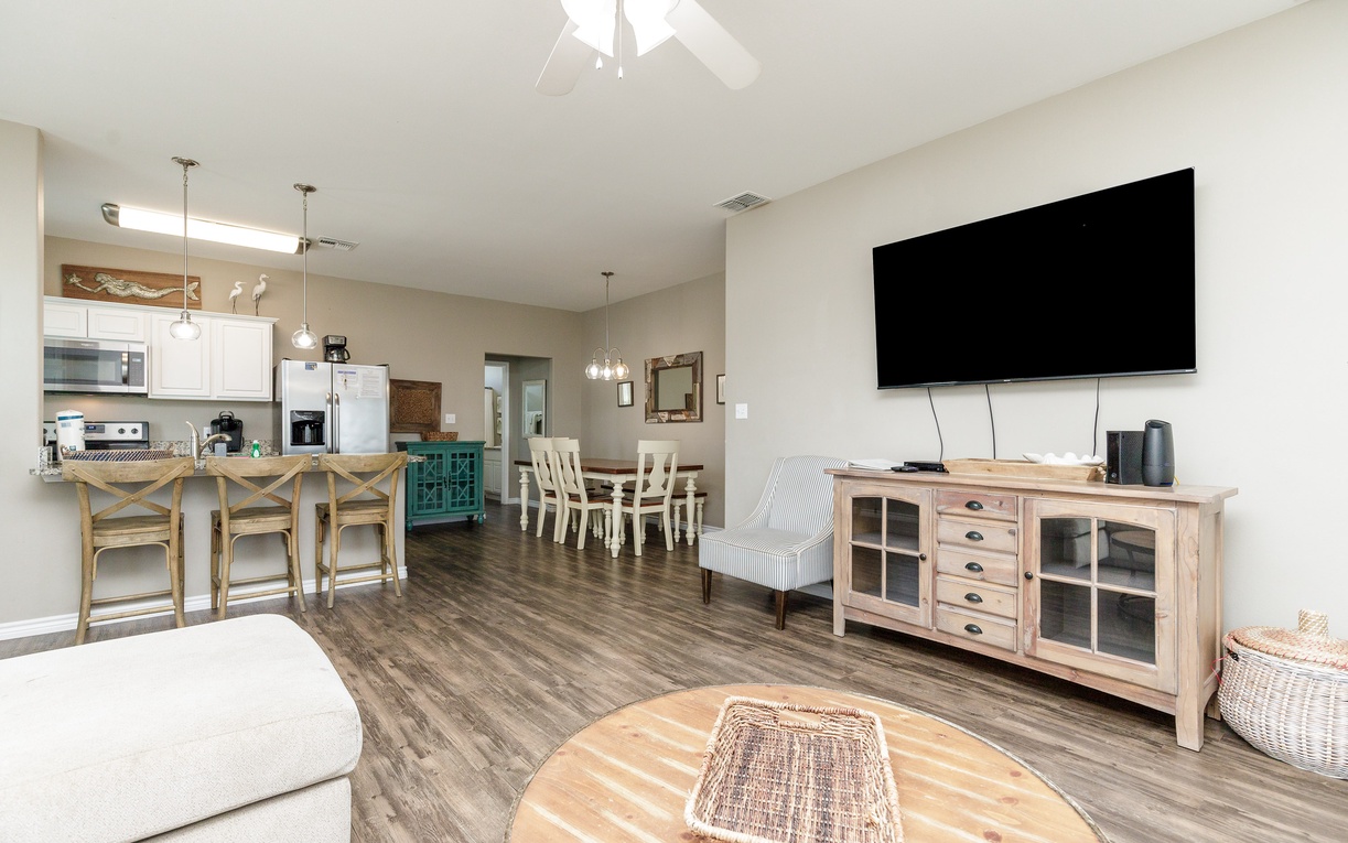 Relax in your spacious open-plan retreat where coastal charm meets modern comfort, featuring a full kitchen and cozy living area.
