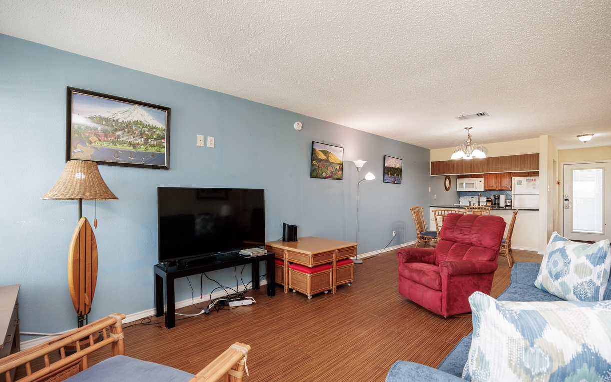 Relax in your spacious living room with plush seating, large TV, and coastal-inspired decor that creates the perfect home base for your getaway.