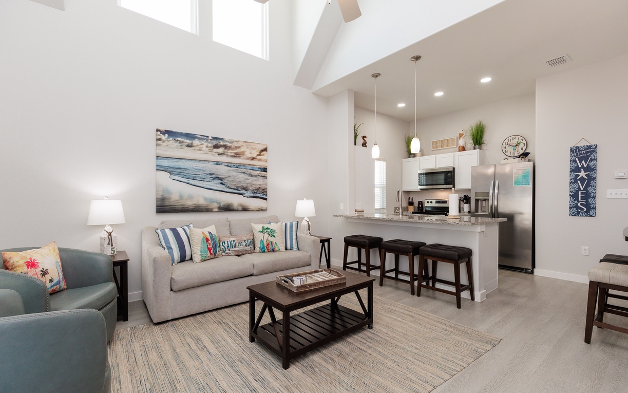 Relax in your bright, airy living space with soaring ceilings and coastal-inspired décor that invites you to unwind completely.