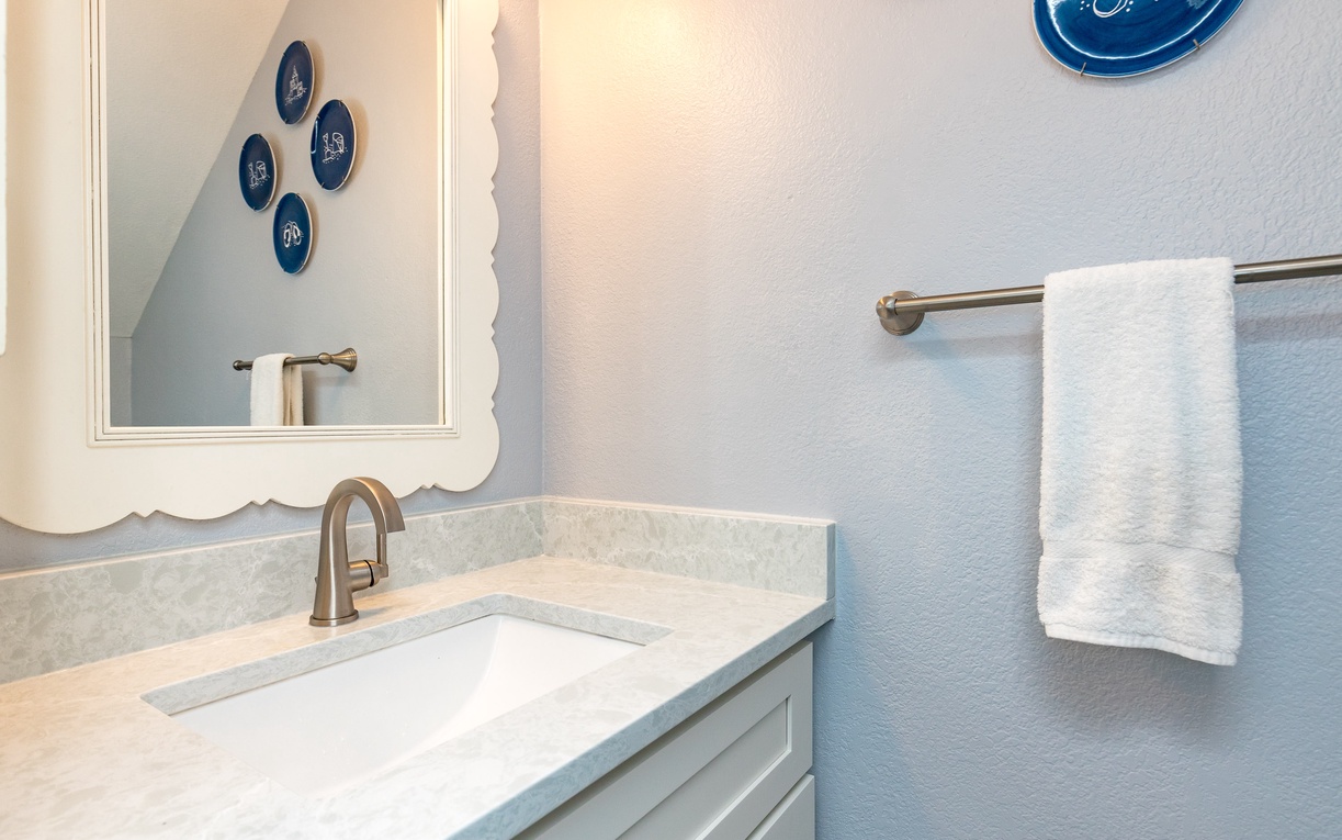 Freshen up in your stylish bathroom with marble countertops, bronze fixtures, and plush towels waiting for your arrival.