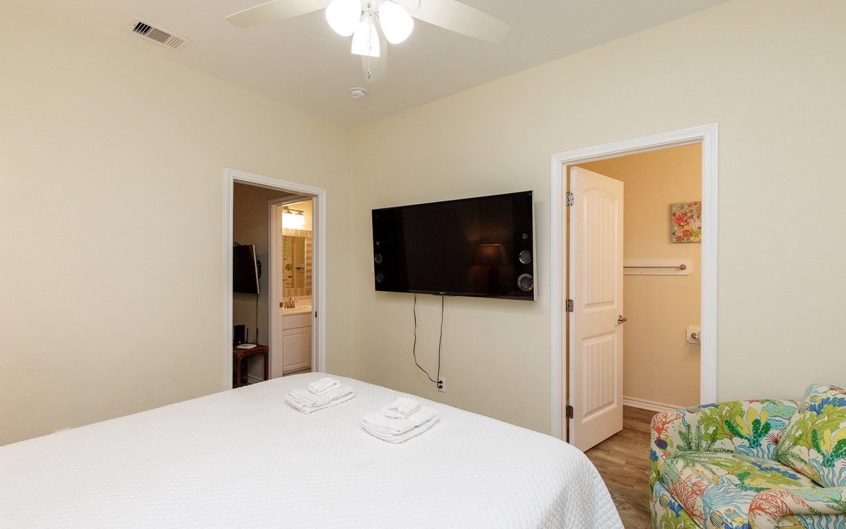 Second floor primary bedroom with a king size bed, private bathroom with walk-in shower, and private balcony access