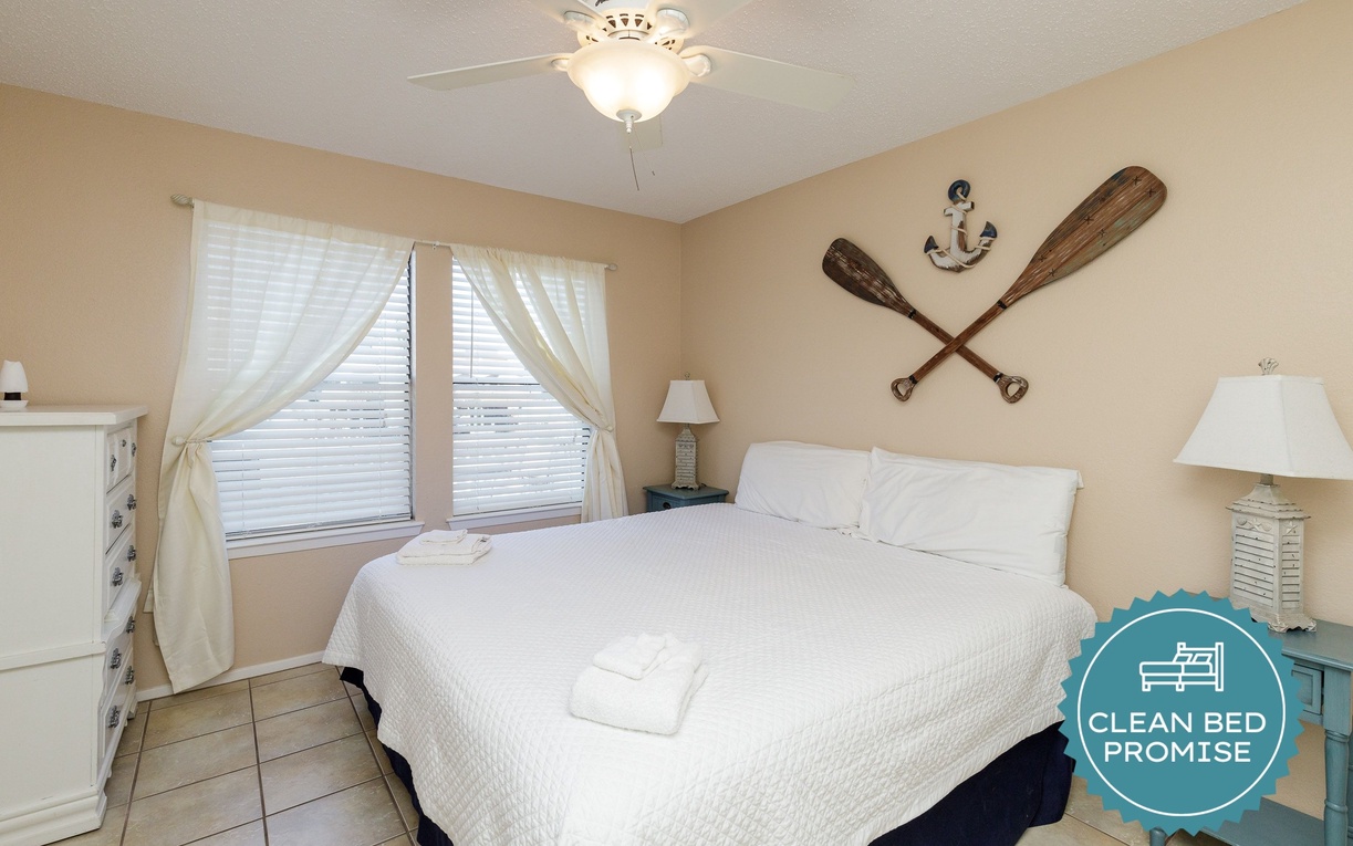 Drift off to sleep in this nautical-themed bedroom with crisp linens and coastal charm beckoning you to rest.
