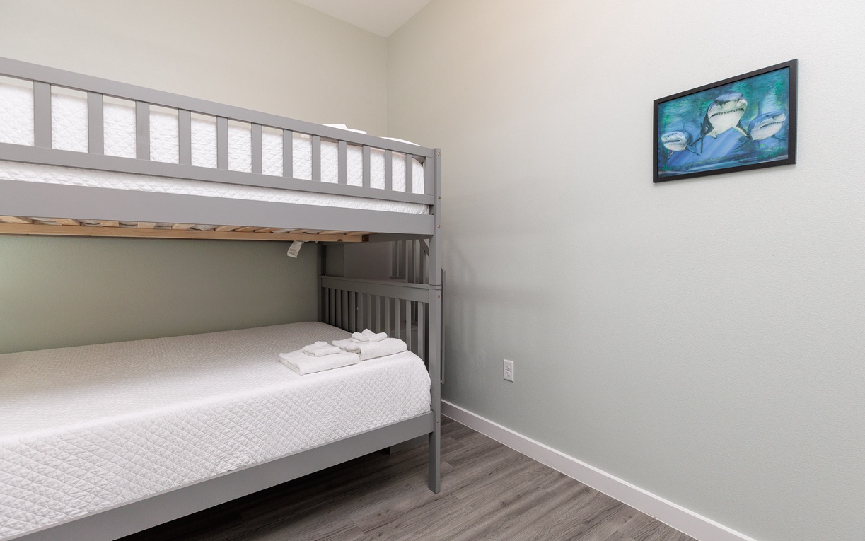Your kids will love this cozy bunk bed room, complete with fresh linens and playful ocean artwork to inspire bedtime adventures.