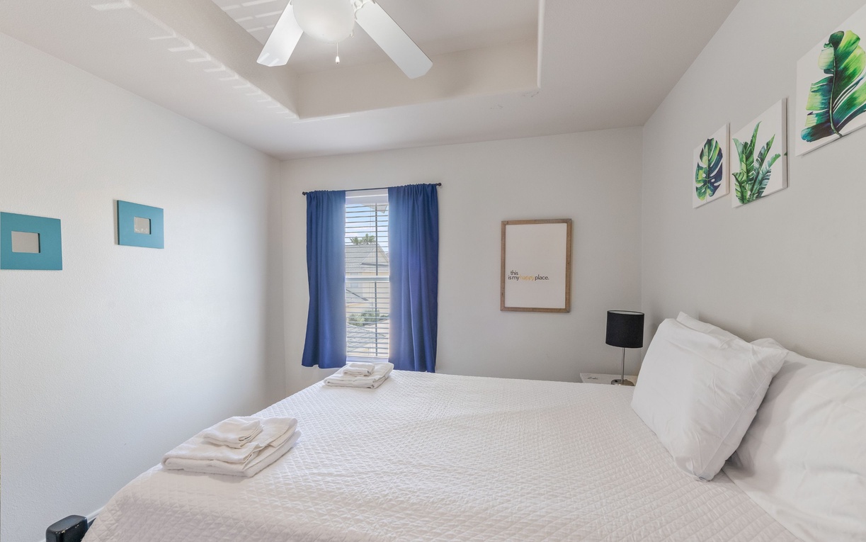 Sink into crisp white linens in your bright, airy bedroom. Fresh towels await and tropical artwork adds a cheerful touch to your peaceful retreat.