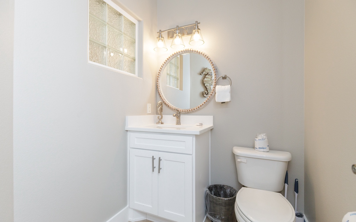 Your pristine powder room features elegant lighting and stylish decor, creating the perfect space to freshen up during your stay.
