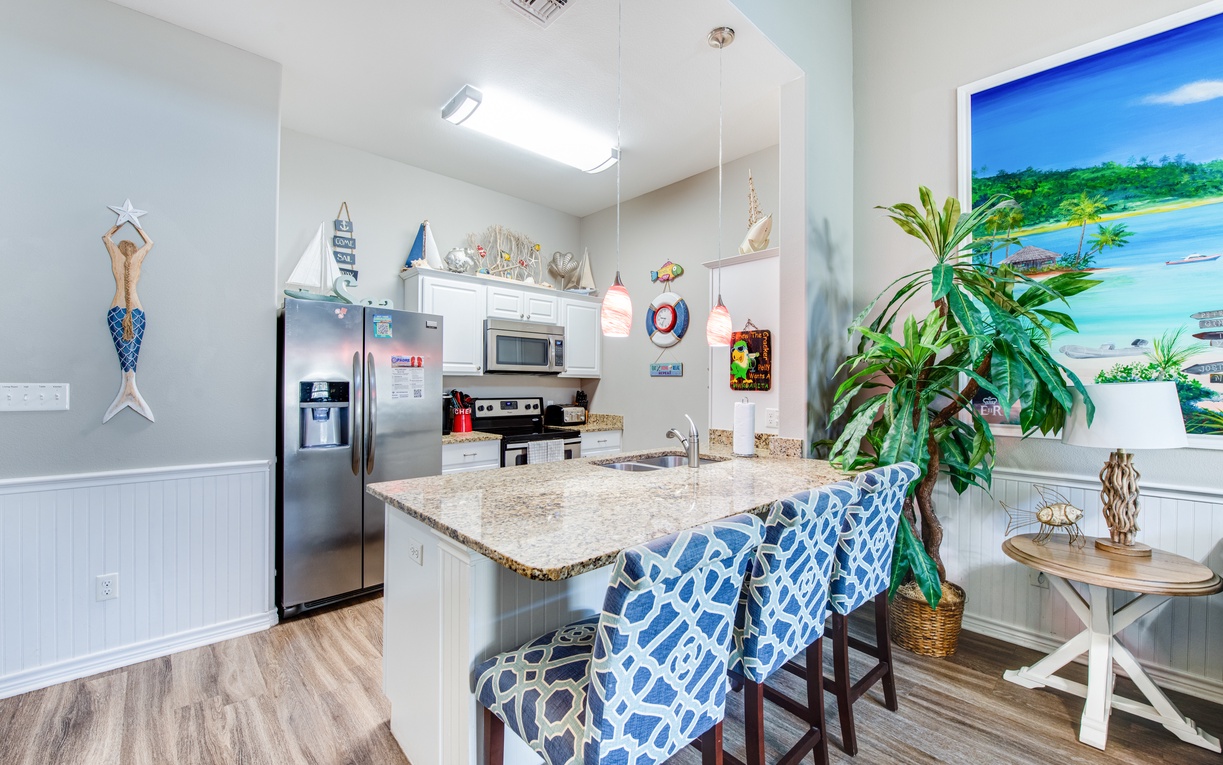 Your coastal-themed kitchen invites culinary adventures with granite counters, modern appliances, and charming nautical touches that make you feel right at home.