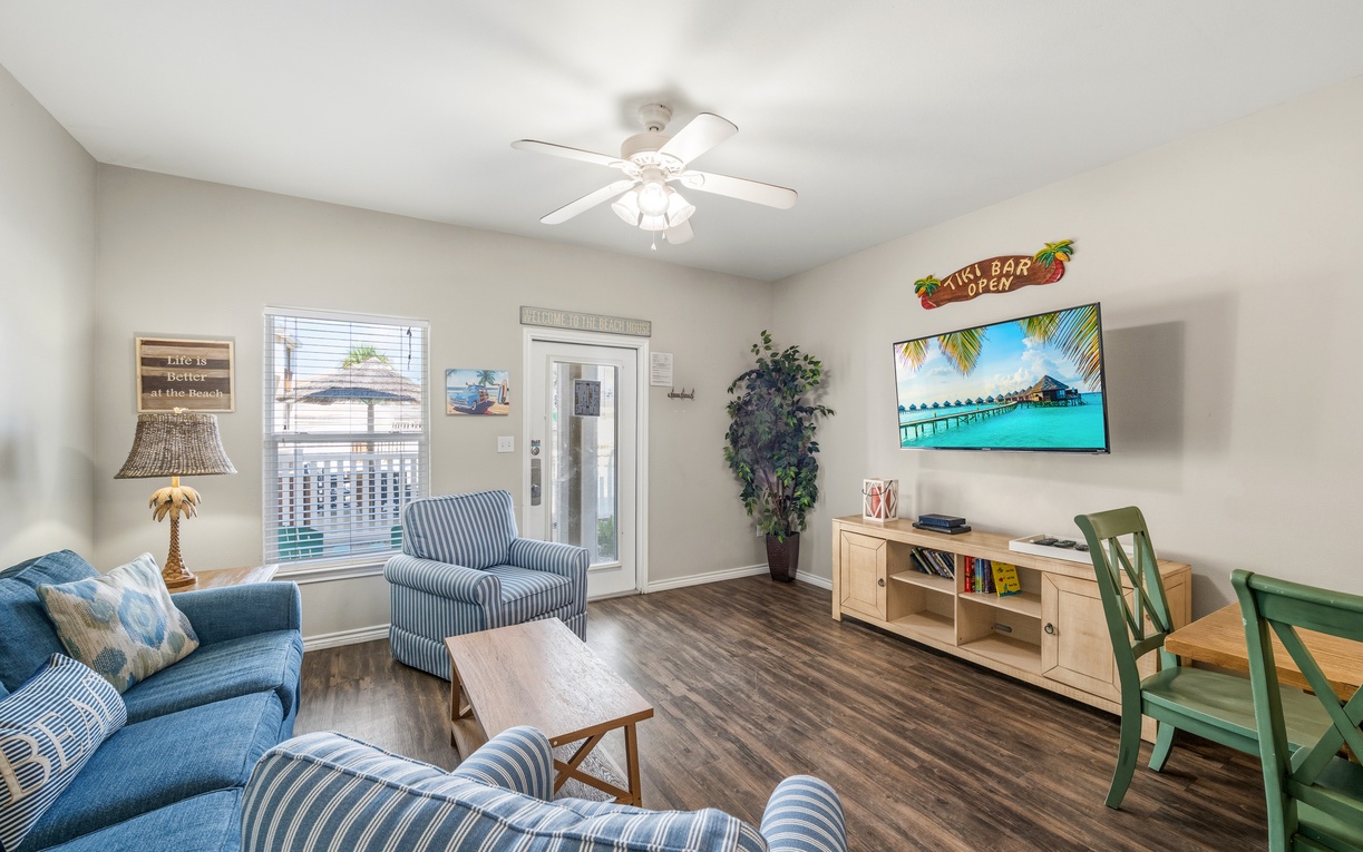 Unwind in your bright, beachy living space with comfy seating, a ceiling fan to keep you cool, and tropical touches that make every moment feel like a getaway.