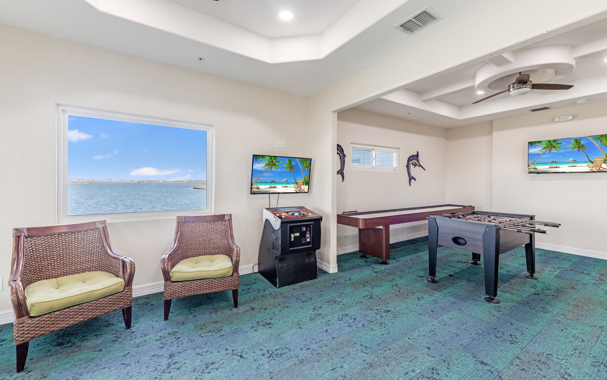Community game room awaits with pool table, arcade games, and stunning water views to keep you entertained for hours.