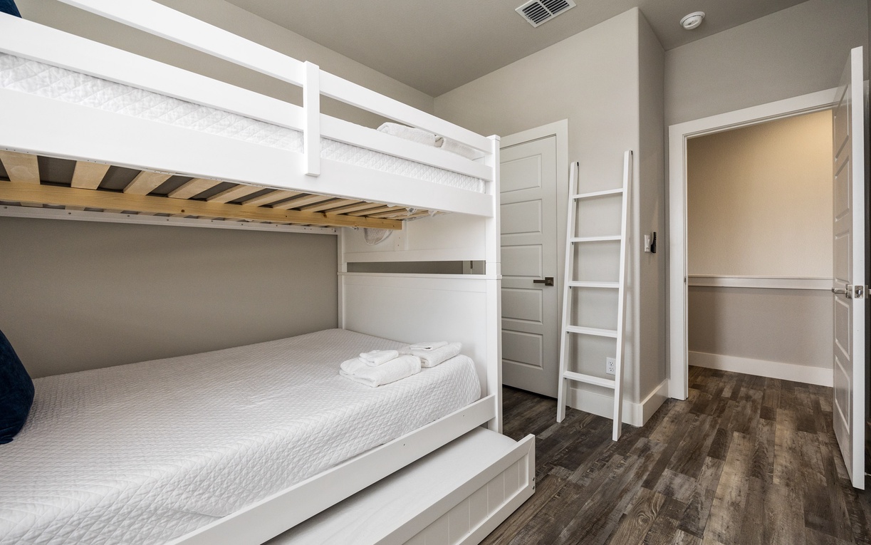 Your cozy bunk room offers comfortable sleeping with crisp white linens and thoughtful built-in storage for a restful night's stay.