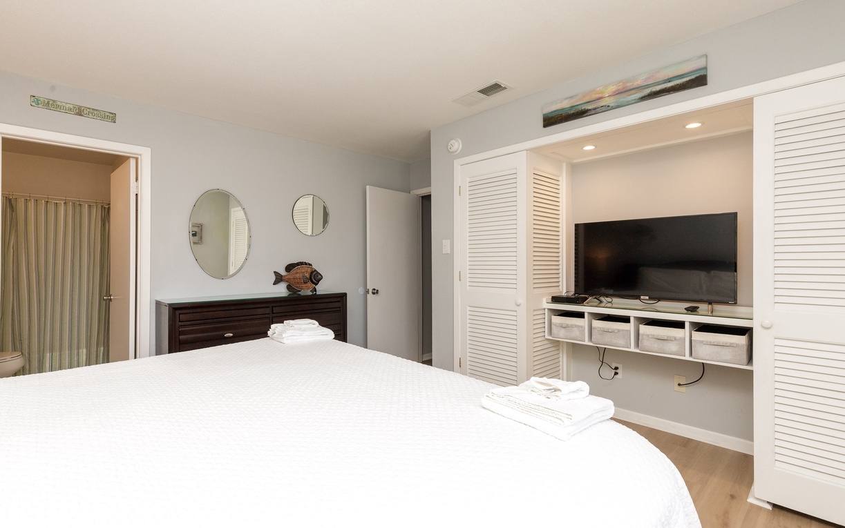 Unwind in your serene bedroom with smart TV entertainment center and custom built-in storage for all your belongings.