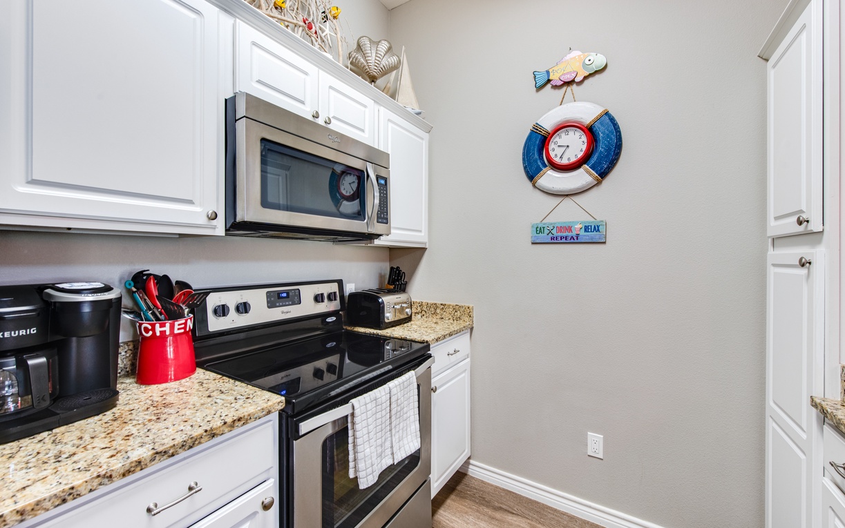 Your fully equipped kitchen features granite counters, stainless appliances, and charming coastal décor for memorable vacation cooking.