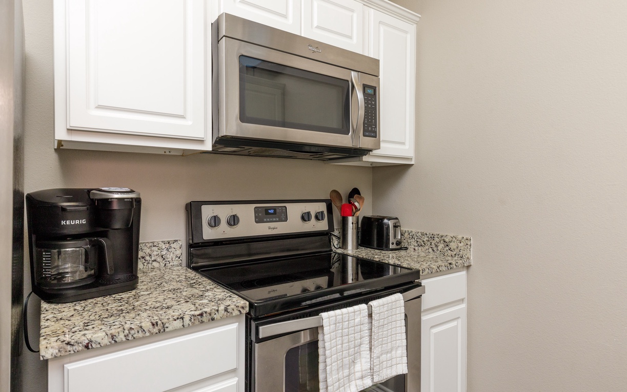 Your fully equipped kitchen awaits with granite counters, stainless appliances, and fresh coffee ready to brew for perfect vacation mornings.