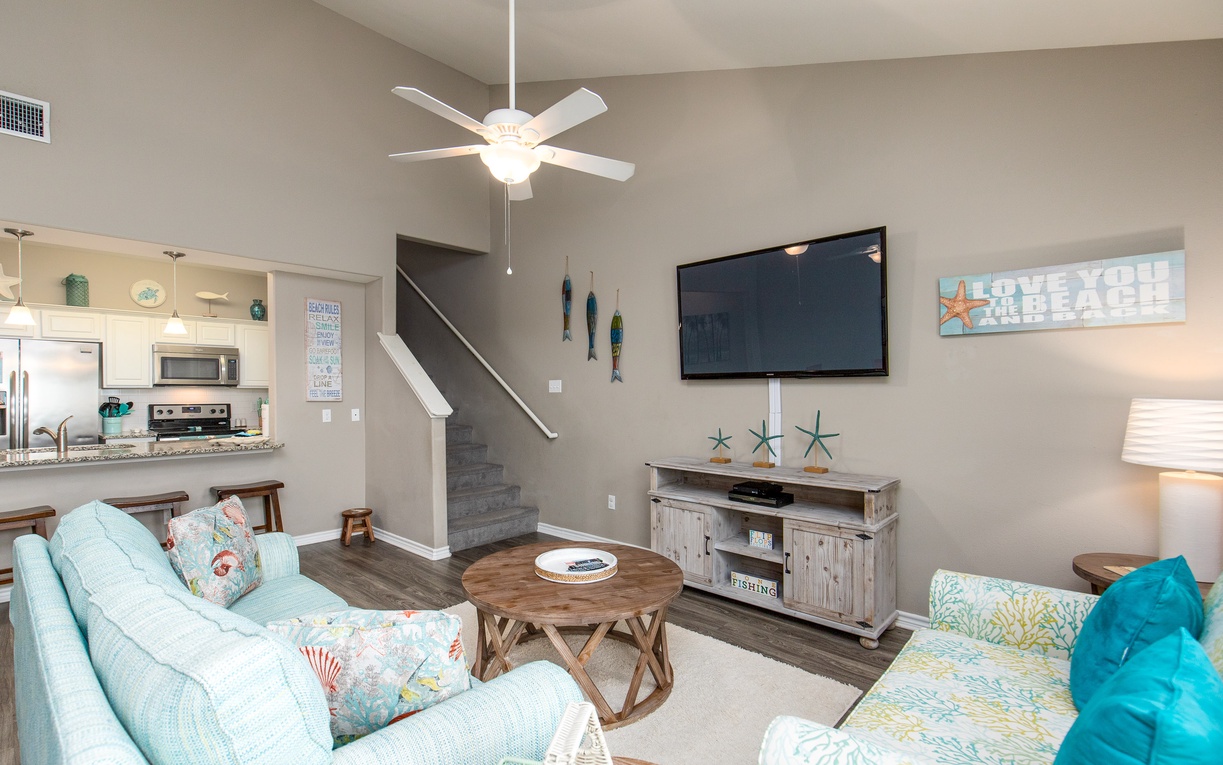 Unwind in your bright living room with coastal touches, comfy seating, and entertainment center for relaxing evenings.