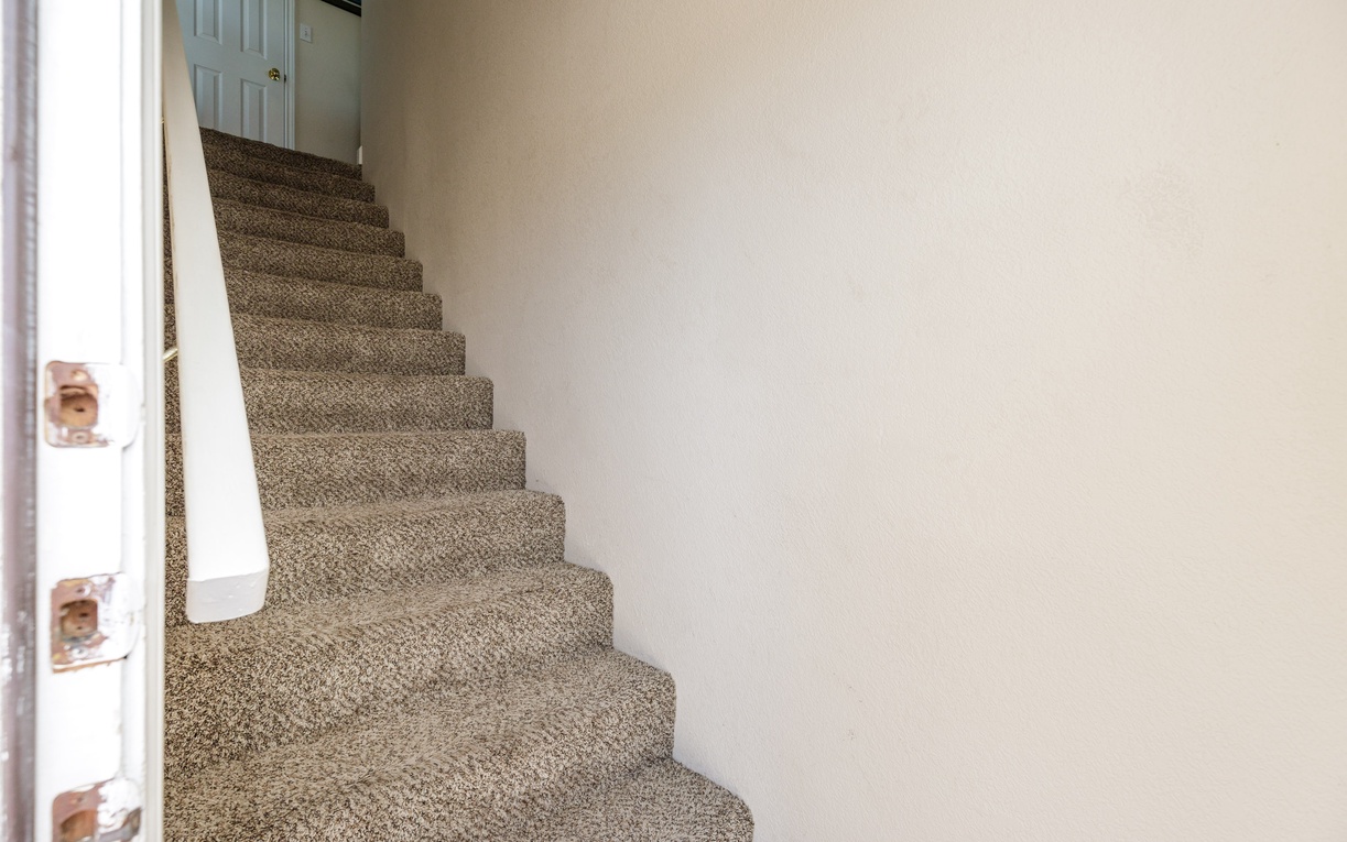 Climb the cozy carpeted stairs to your private upstairs retreat, where comfort awaits in every step.