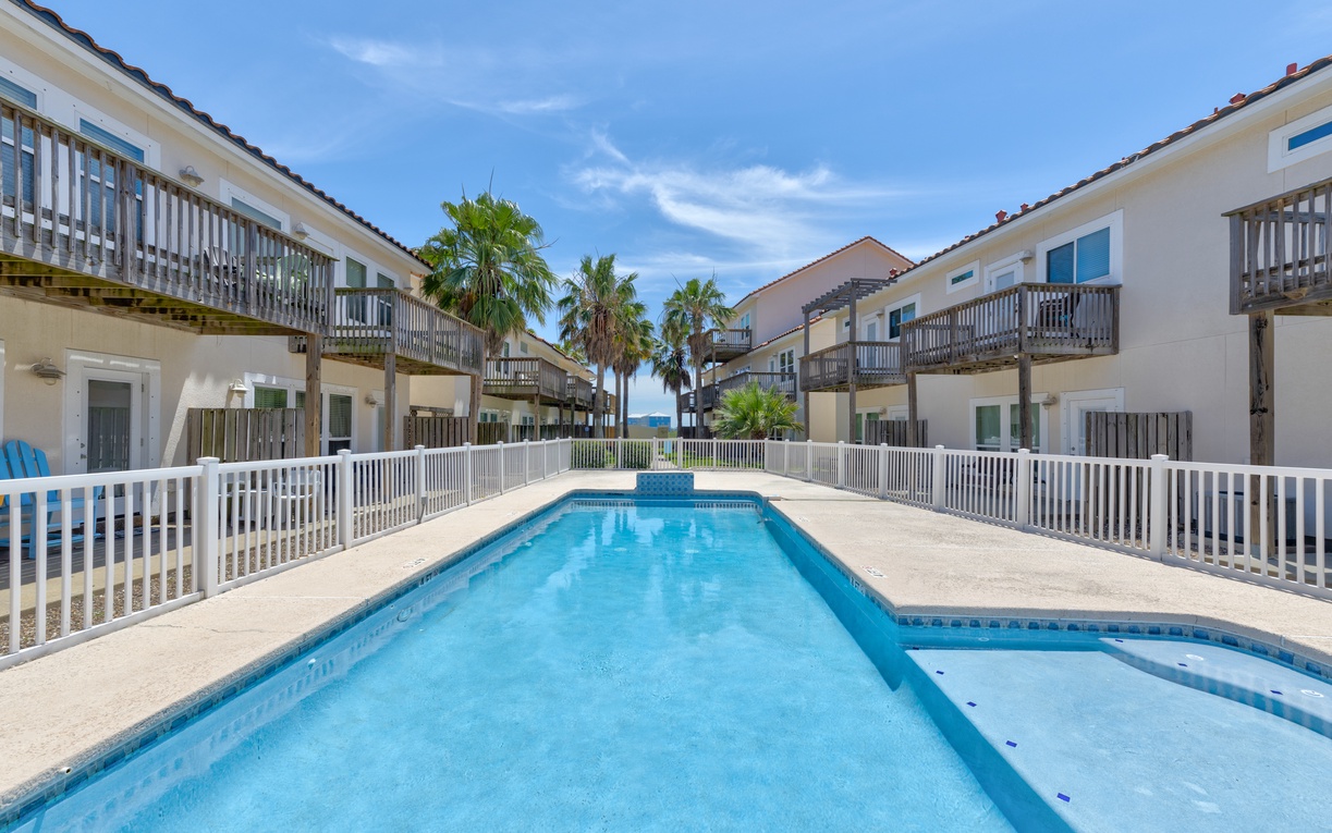 Cool off in the inviting outdoor pool, surrounded by palm trees and just steps from the beach. A perfect spot to relax under the sun.