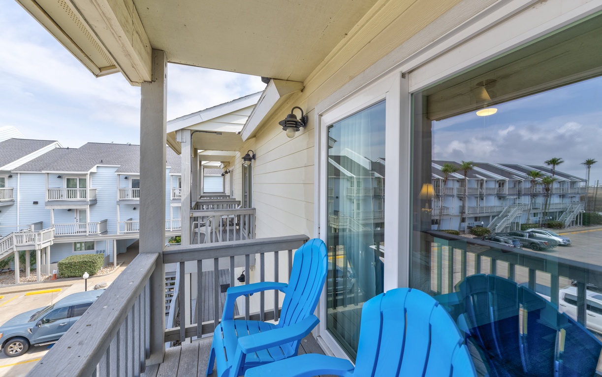 Step onto your private balcony where bright blue Adirondack chairs await your morning coffee or evening unwind.