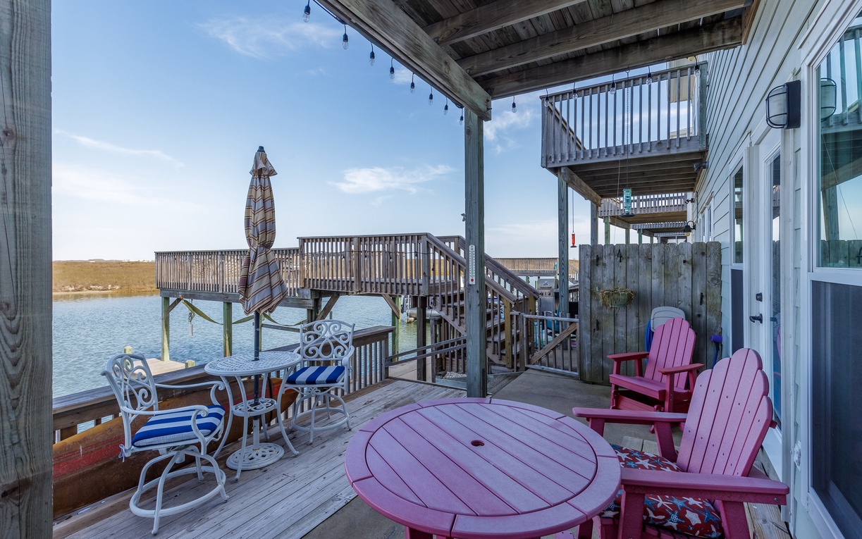 Unwind on your private waterfront deck with colorful Adirondack chairs and stunning lake views—perfect for morning coffee or evening relaxation.