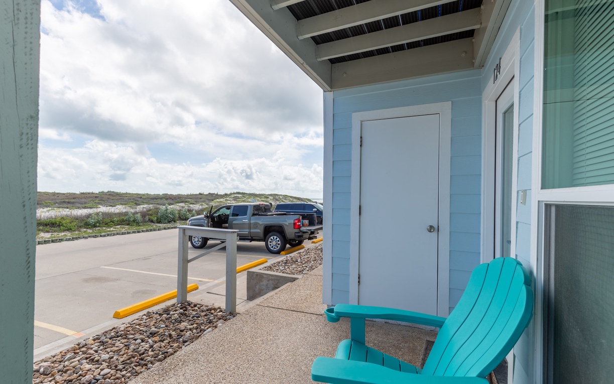 Relax on your private patio with turquoise chairs overlooking open landscapes, perfect for morning coffee or evening unwinding.