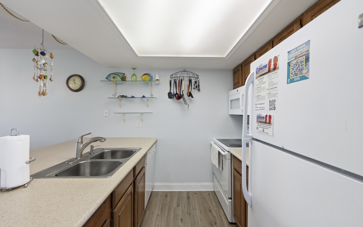 A fully equipped kitchen awaits you, featuring double sinks, ample storage, and all the essentials for preparing your favorite meals during your stay.