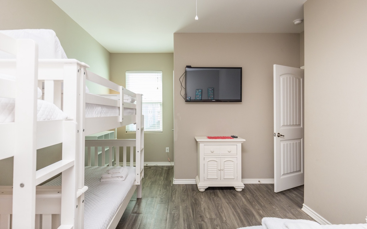 Your family will love this cheerful room with sturdy bunk beds and entertainment center for cozy movie nights together.