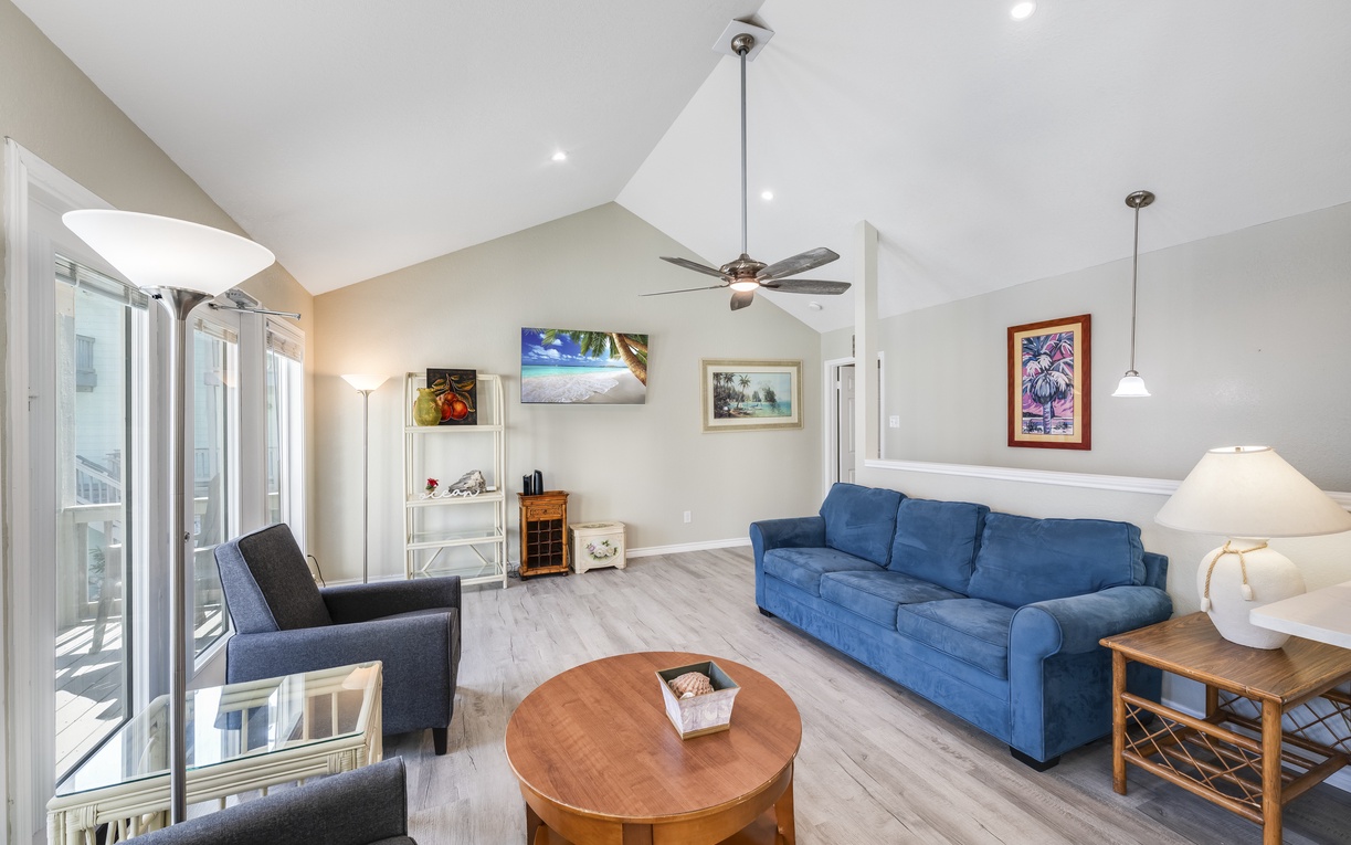Sink into plush seating in your bright, airy living room with coastal artwork and modern comfort.