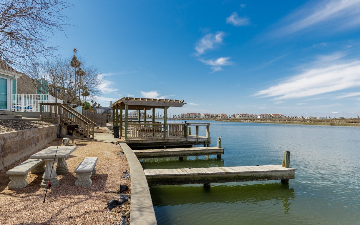 Waterfront property featuring private dock access and scenic lake views with distant residential neighborhoods.