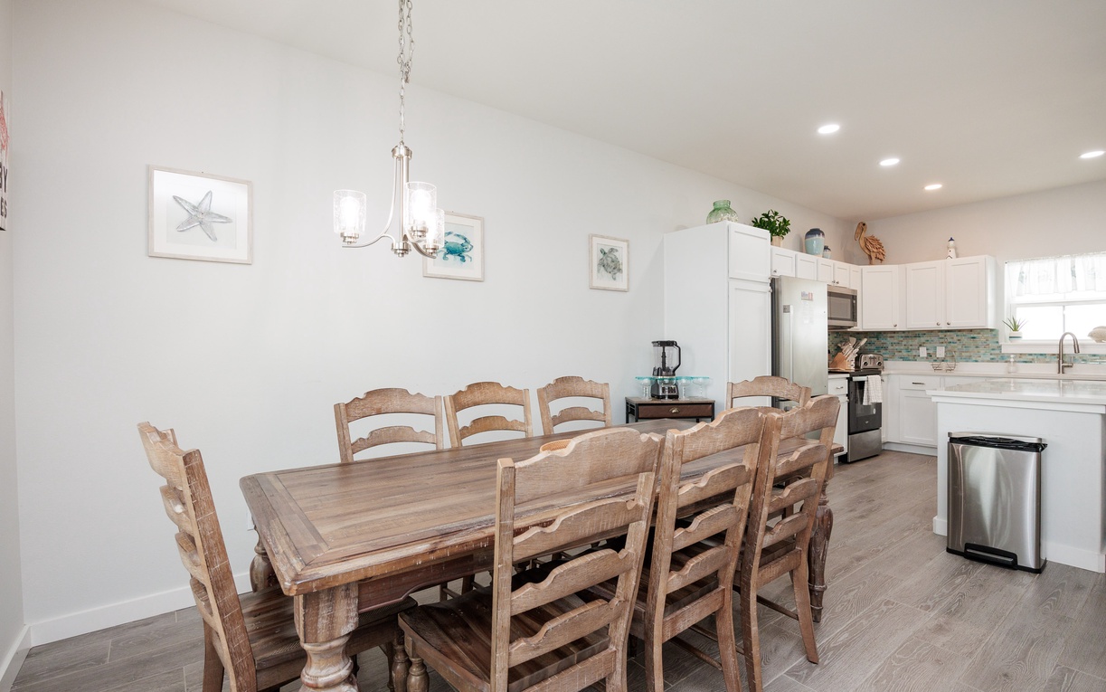 Gather around this beautiful farmhouse dining table where your group can share meals and make memories in the bright, coastal-inspired kitchen.