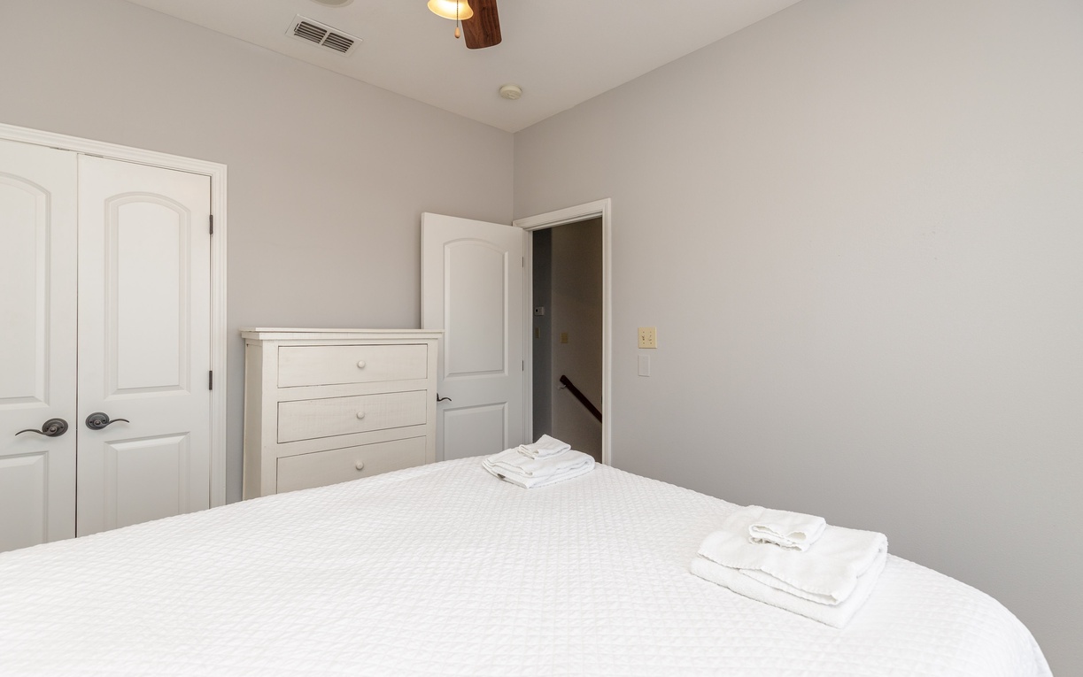 Sink into crisp white linens in your peaceful bedroom retreat, complete with ample storage and thoughtful touches for ultimate comfort.