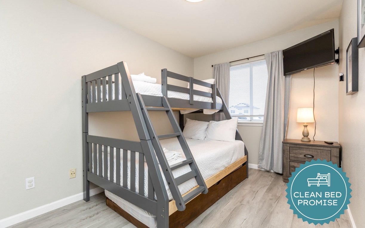 Your family will love this cozy bunk room with crisp white bedding and warm wood accents, perfect for creating lasting vacation memories together.