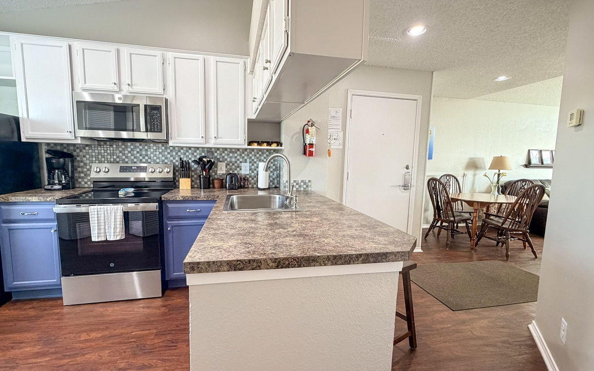 Your fully equipped kitchen features granite countertops, stainless steel appliances, and an open layout that flows seamlessly into the dining area.