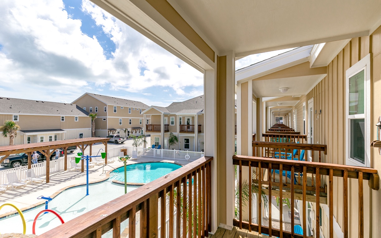 Step onto your private balcony and soak in the pool views below, where sunny days await your perfect getaway.