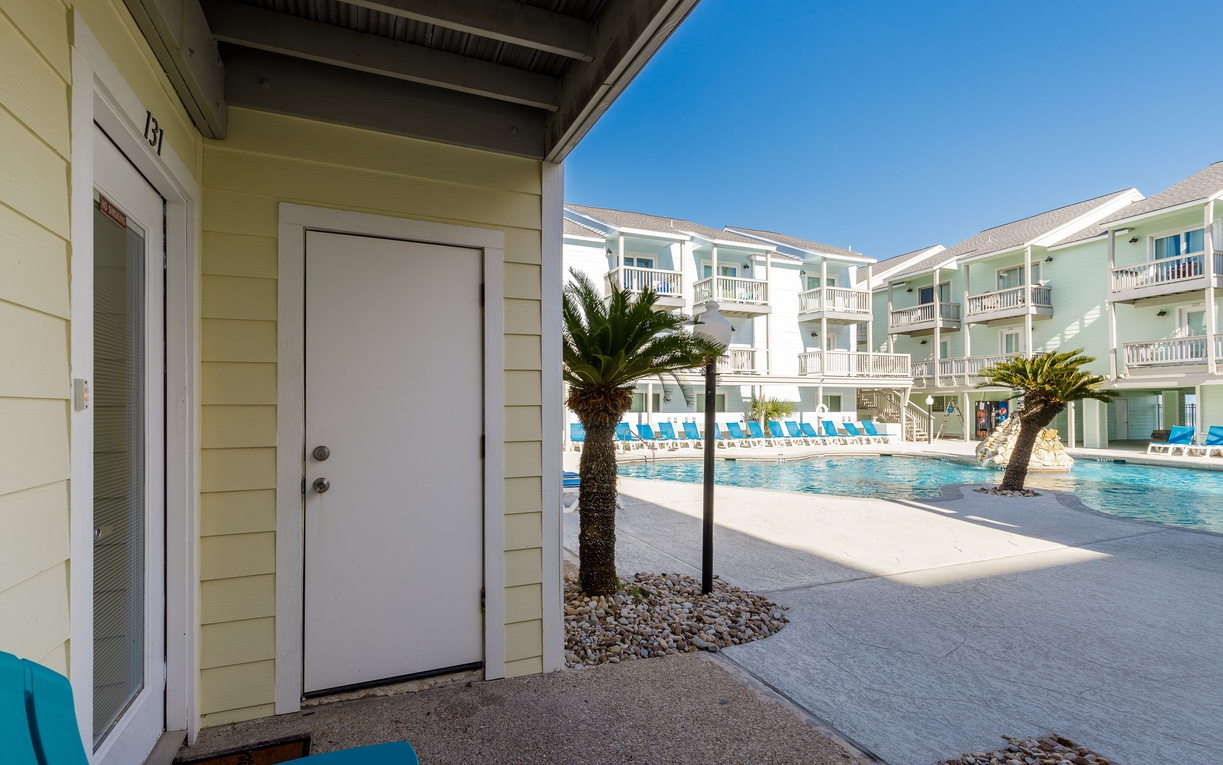 Step outside your door to tropical paradise—sparkling pool, swaying palms, and endless blue skies await just steps away.