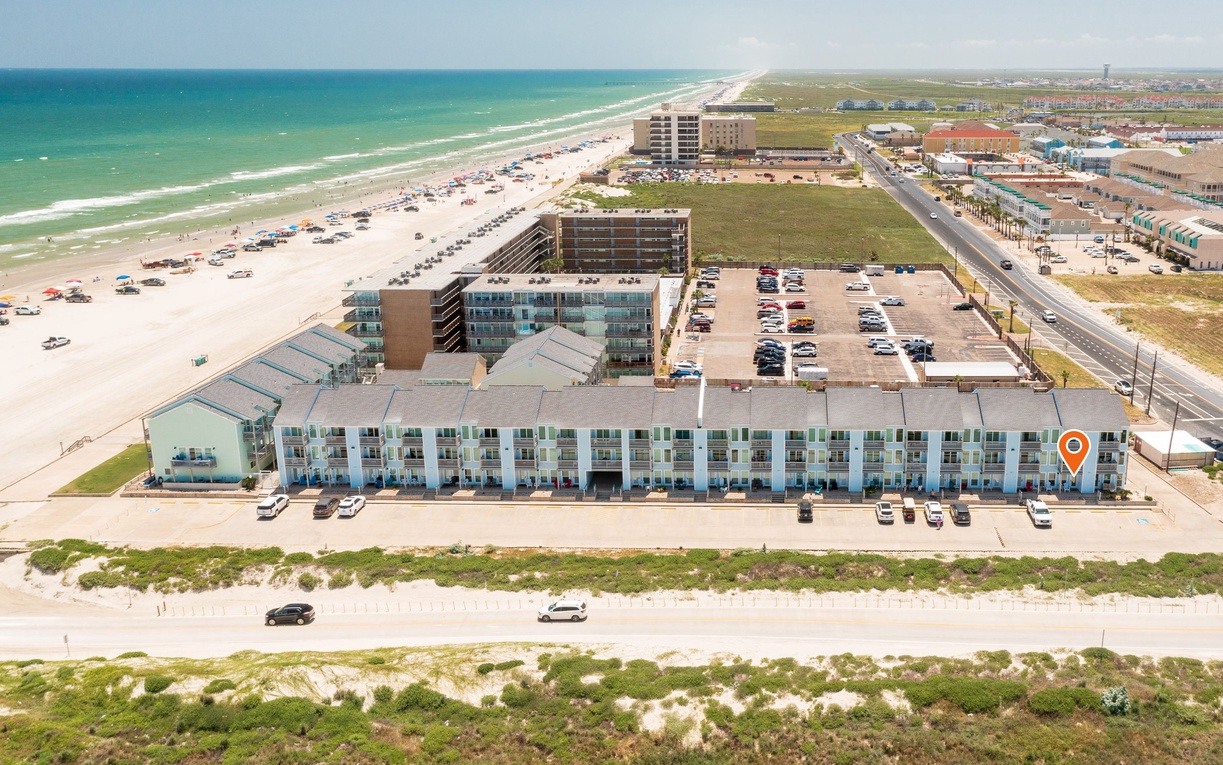 Beachfront resort property with direct beach access and ocean views, located steps from the sandy shore.