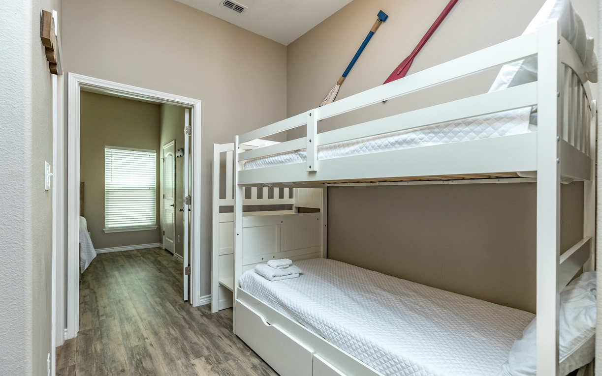 Your kids will love these sturdy white bunk beds with fresh linens and plenty of room to sleep comfortably together.