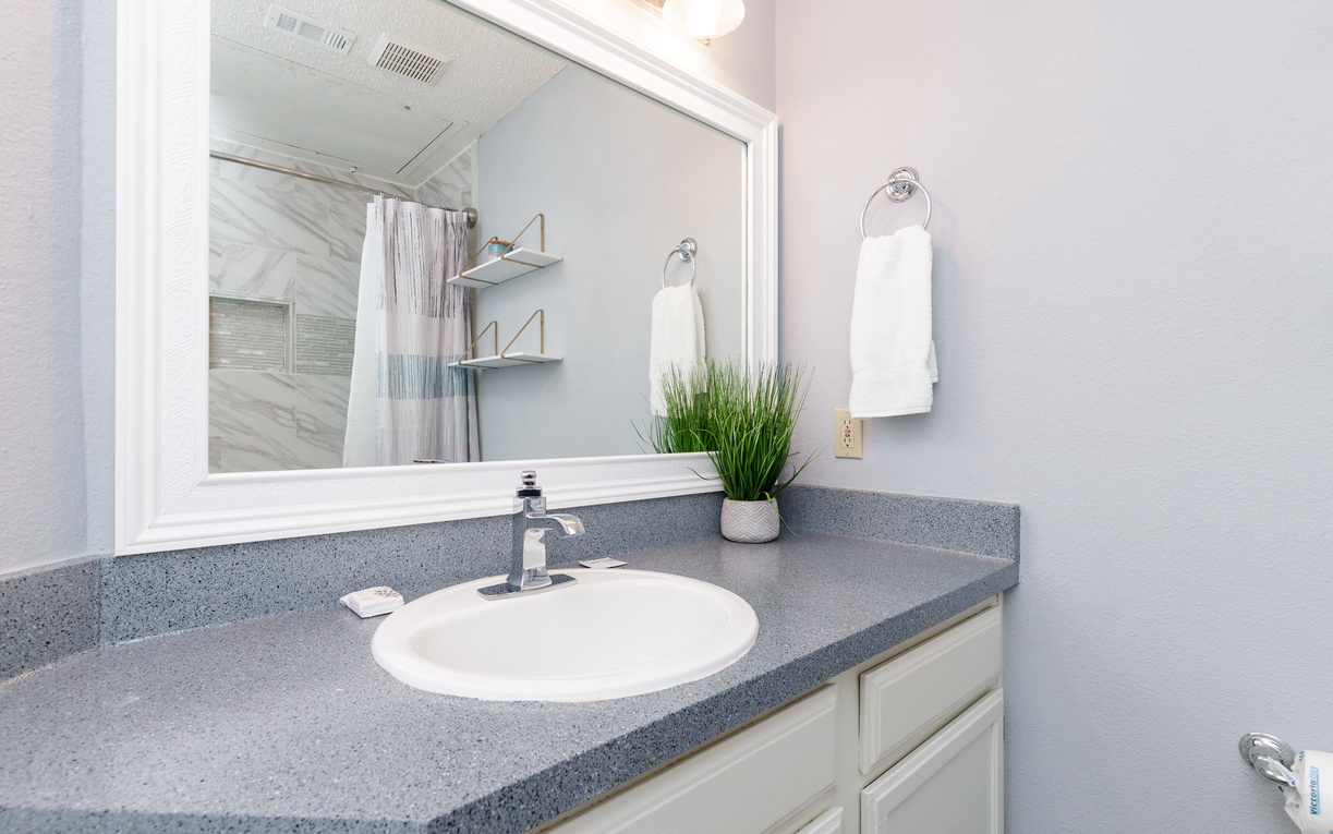 Fresh towels await in this bright, clean bathroom with modern fixtures and thoughtful touches for your comfort.