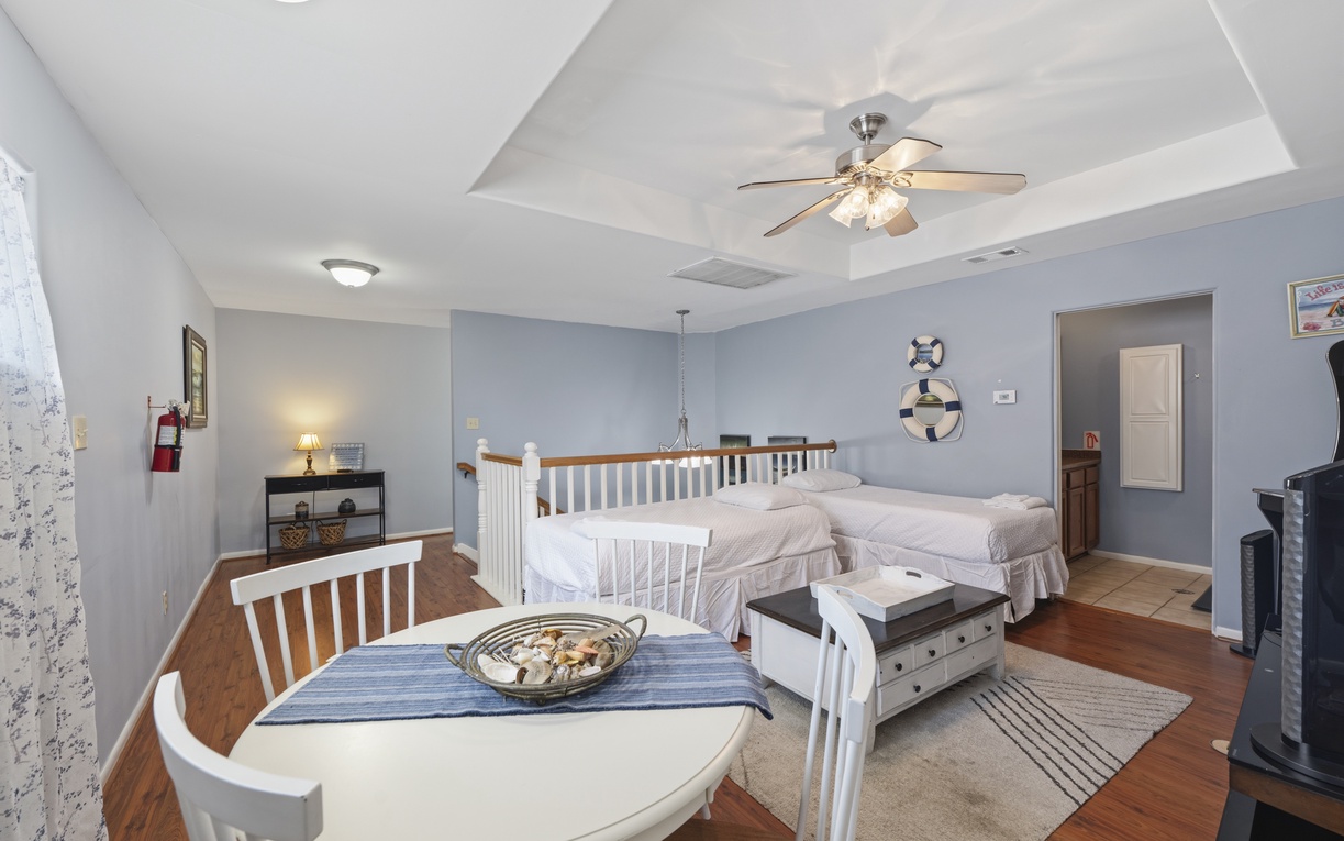 Your cozy retreat features soothing coastal tones, a ceiling fan for comfort, and a relaxed dining nook where you can enjoy morning coffee before starting your day.