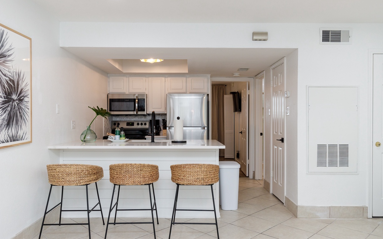 Your bright, modern kitchen features sleek appliances and a welcoming breakfast bar where you can enjoy morning coffee or casual meals.