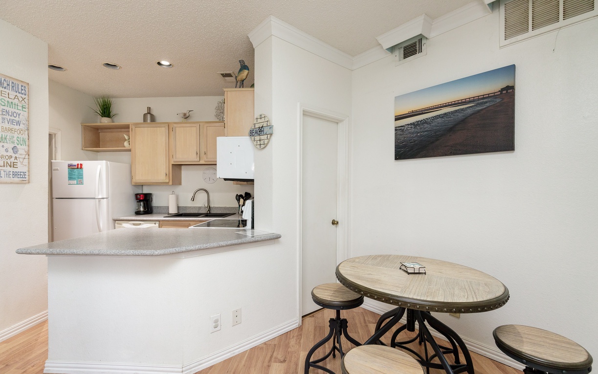 Your bright kitchen flows into a cozy dining space where you'll savor morning coffee and plan beach adventures.