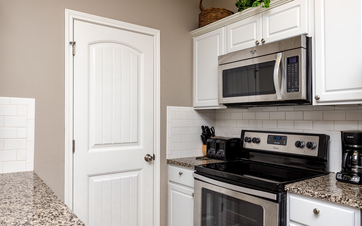 Your bright kitchen awaits with granite counters, stainless appliances, and everything needed for your culinary adventures.