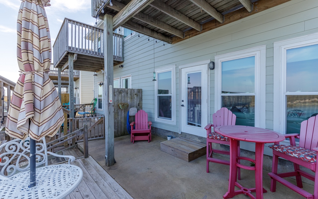 Unwind on your private patio with vibrant pink furniture and ocean breezes, perfect for morning coffee or sunset cocktails.