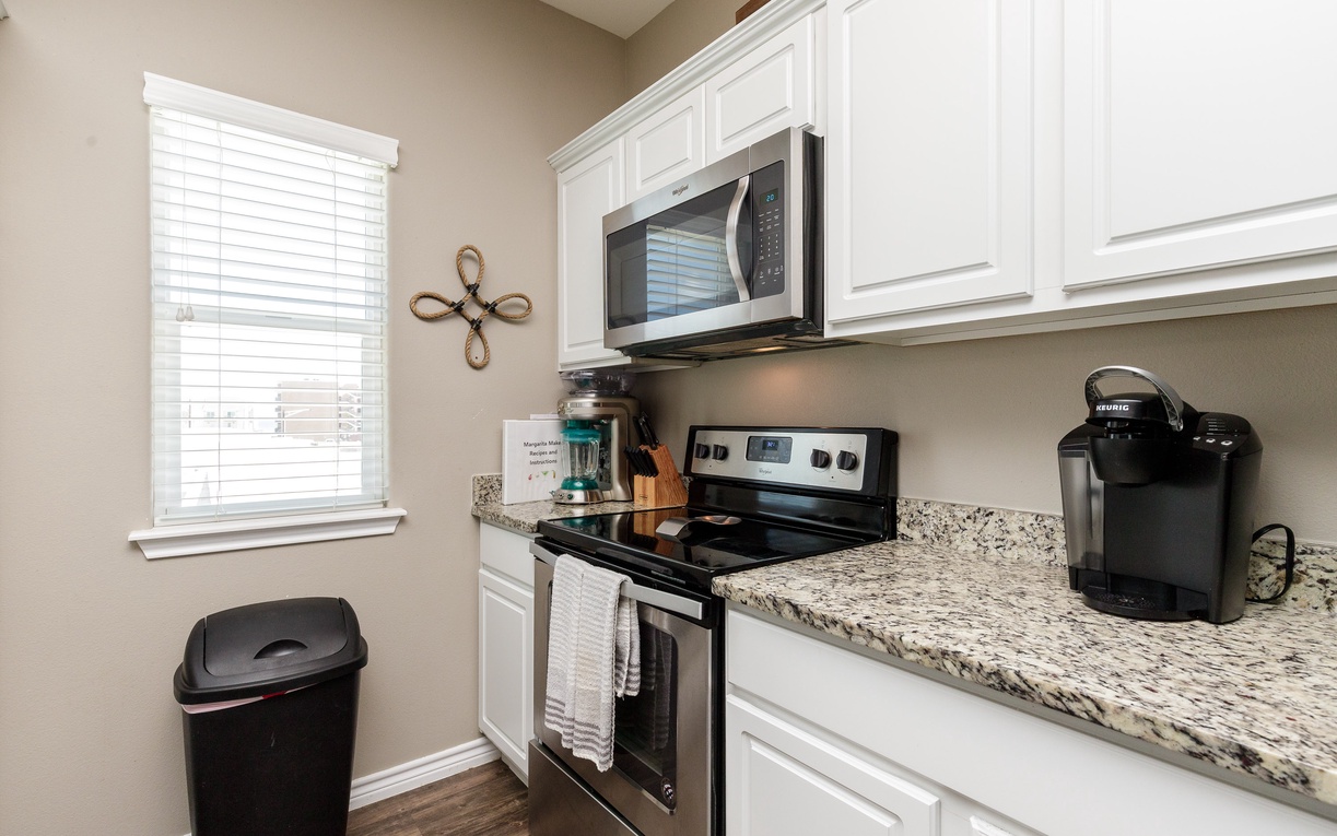 Your fully equipped kitchen features granite counters, stainless appliances, and a Keurig for easy morning coffee brewing.