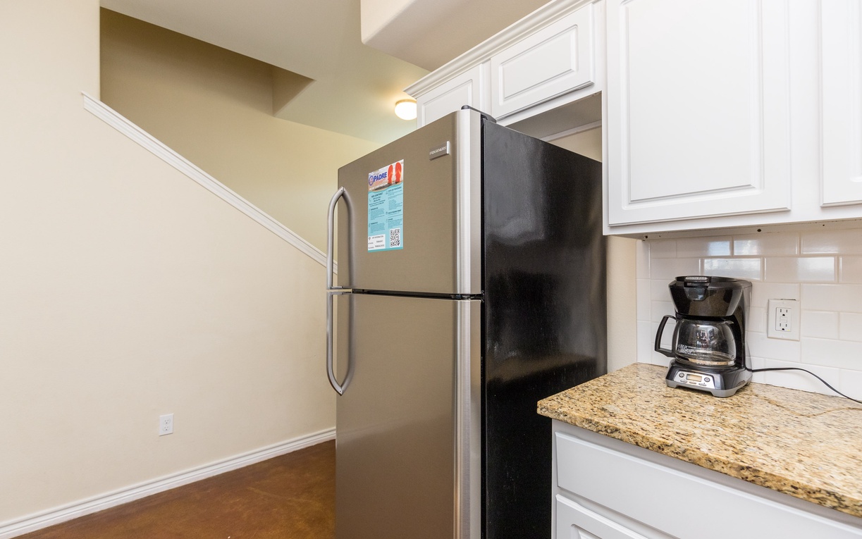 Your well-appointed kitchen features a full-sized refrigerator and coffee maker, perfect for preparing meals and brewing morning coffee during your stay.